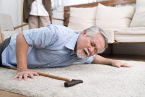 old man with cane falling at home