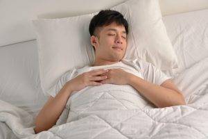 Handsome,Young,Asian,Man,Sleeping,In,Bed