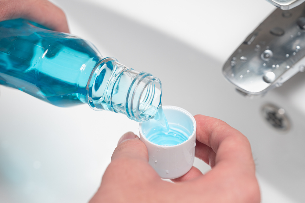 Mouthwash pouring into cup