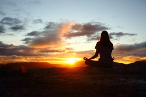 emotional well-being, asian woman practising yoga with sunset background