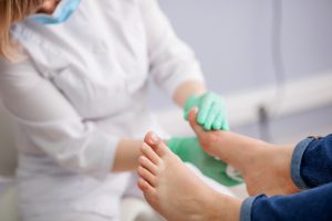 diabetic foot infection doctor checking foot for diabetes complication
