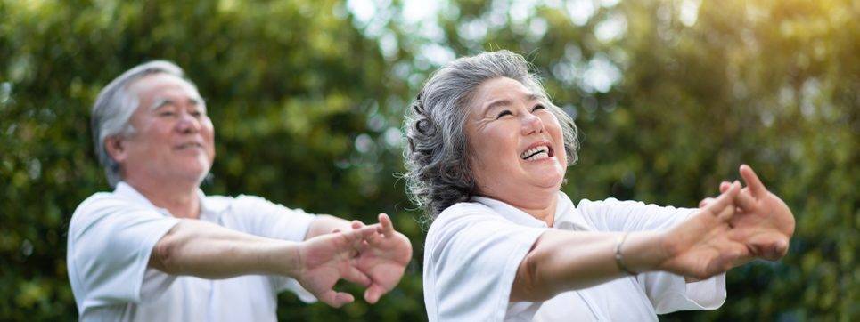 elderly man and woman stretching