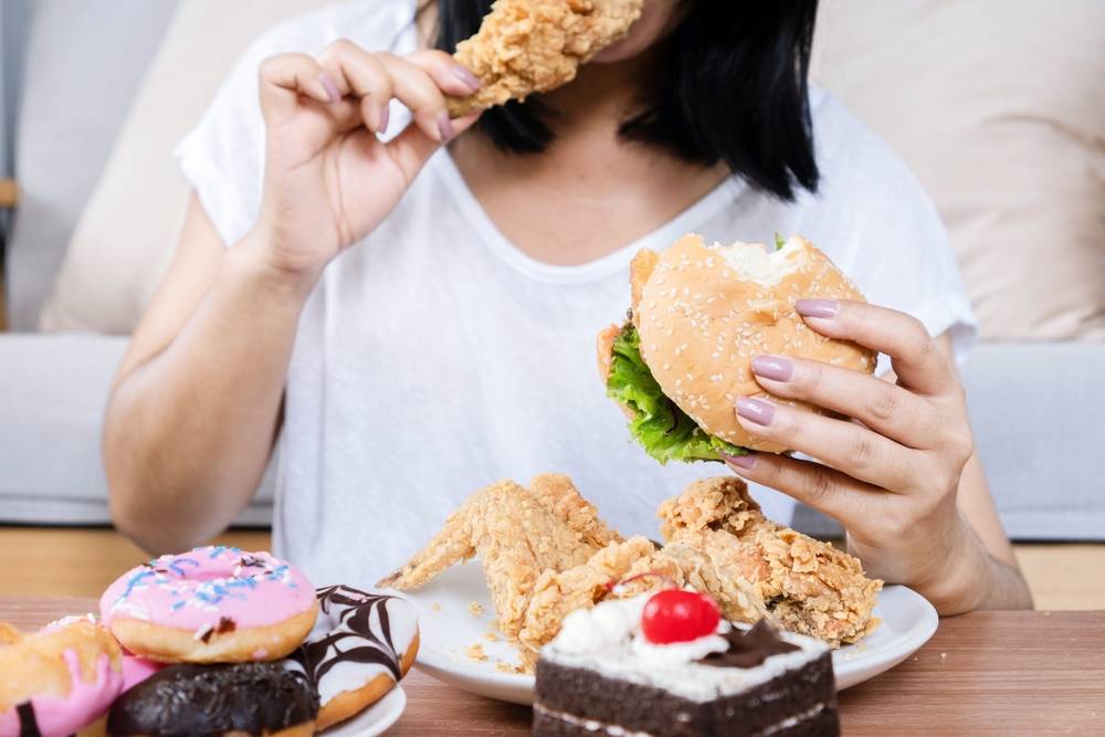 Binge,Eating,Disorder,Concept,With,Woman,Eating,Fast,Food,Burger,