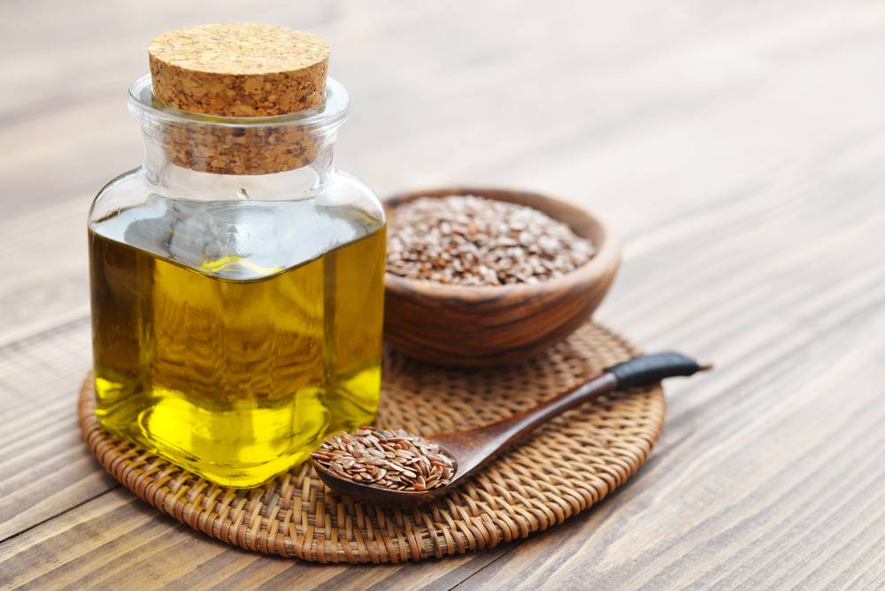 Flax,Seeds,And,Oil,In,Bottle,On,Wooden,Background