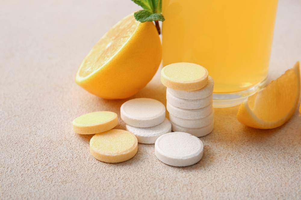 Vitamin,C,Effervescent,Tablets,And,Lemons,On,Beige,Grunge,Table