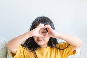Healthy,Eyes,And,Vision.portrait,Happy,Asian,Kid,Child,Holding,Heart