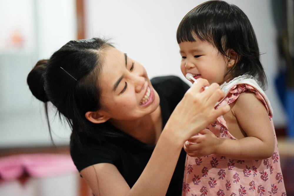 Mother,Is,Teaching,Her,Kid,To,Brush,Her,Teeth.