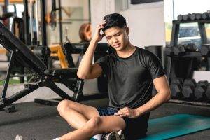 A,Young,Handsome,Asian,Man,Suffering,From,A,Headache.,Looking