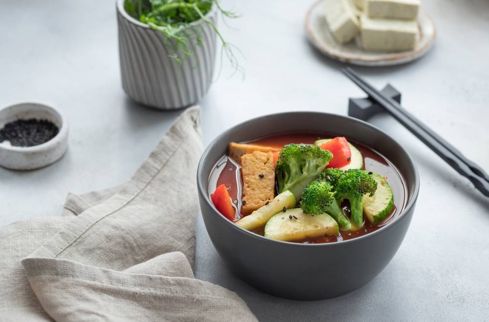 Asian,Vegan,Soup,With,Tofu,Cheese,And,Vegetables,In,Dark