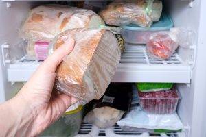 A,Hand,Putting,A,Package,Of,Brown,Bread,In,Reserve