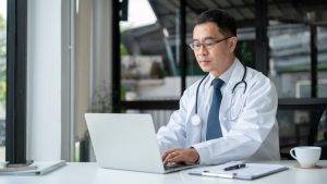 A,Professional,Senior,Asian,Male,Doctor,Is,Working,On,His
